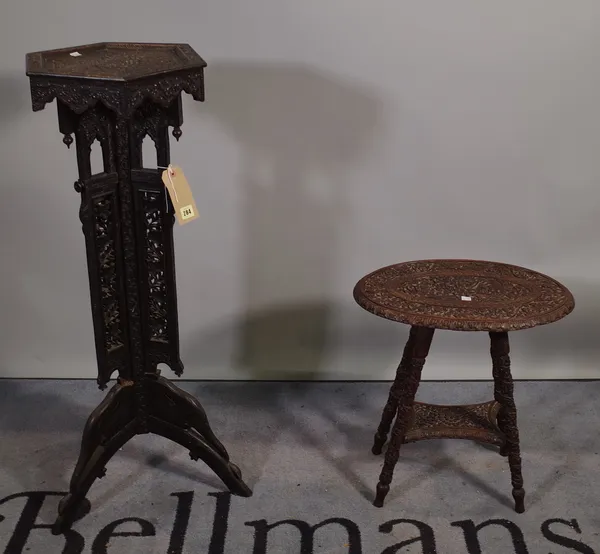 An early 20th century Burmese carved hardwood jardinière stand with octagonal top on three outswept supports, 36cm wide x 98cm high and a similar carv