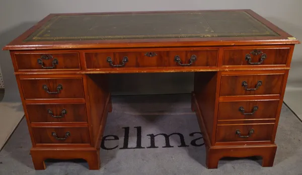 A 20th century mahogany pedestal desk with tooled green leather inset top, 136cm wide x 80cm high.