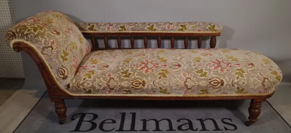 A Victorian walnut framed upholstered chaise longue, on turned supports, 190cm long x 77cm high.