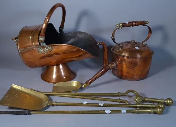 A 19th century copper helmet shaped coal scuttle, a large kettle and a set of brass fire tools, (5).