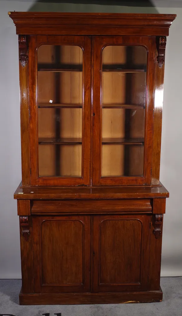 A Victorian mahogany bookcase cabinet, with a pair of glazed doors, over single drawer and cupboard base, 109cm wide x 210cm high.