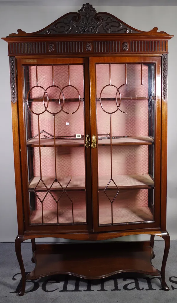 An early 20th century mahogany display cabinet, with pair of glazed doors, resting on cabriole supports, united by undertier, (a.f.) 101cm wide x 190c