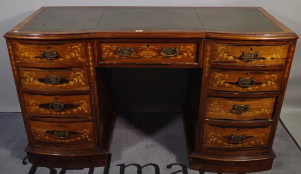 A Victorian rosewood inlaid double bowfront writing desk, with gilt tooled green leather top and an arrangement of nine drawers, 133cm wide x 80cm hig