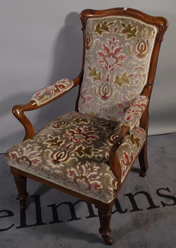 A Victorian rosewood framed upholstered armchair, resting on turned tapering supports, 61cm wide x 97cm high.