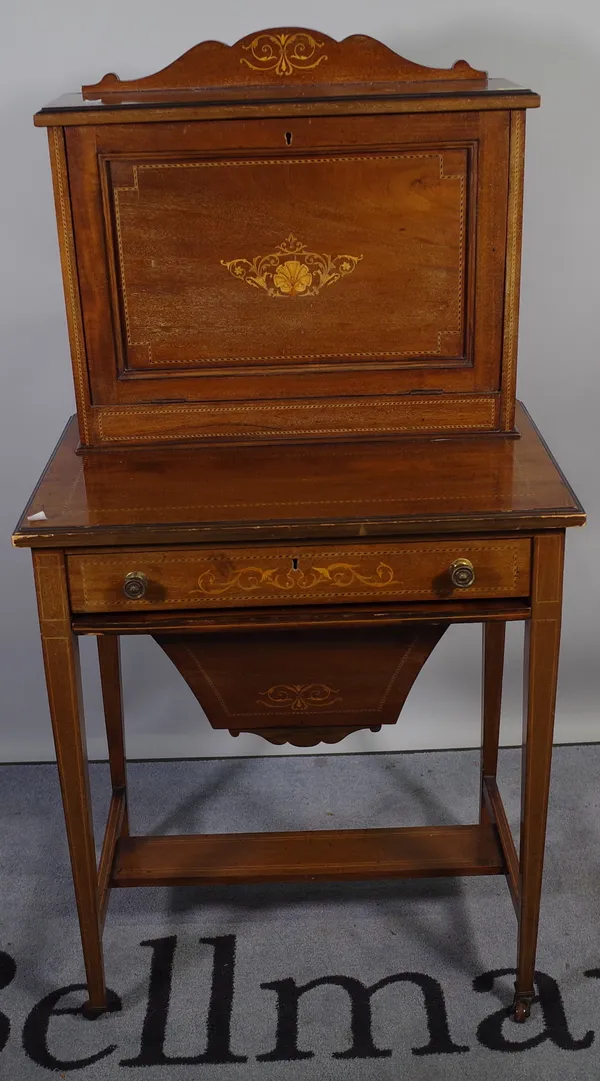 An Edwardian mahogany inlaid writing desk of unusual form, the fall enclosing a fitted interior over a two tier base with pull-out basket, 61cm wide x