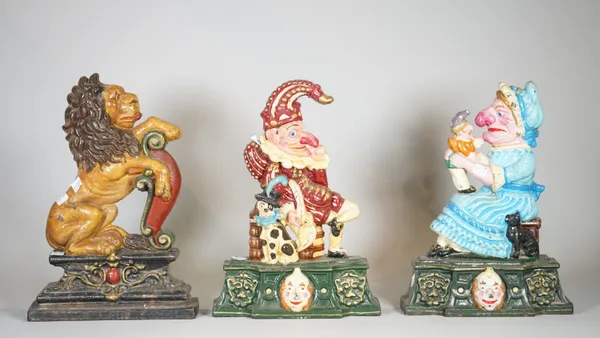 A group of three 20th century painted cast iron door stops, Punch & Judy and a lion, each 35cm high, (3).