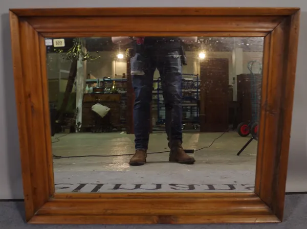 An early 20th century pine wall mirror with deep moulded frame and inset bevelled glass, 83cm x 67cm.