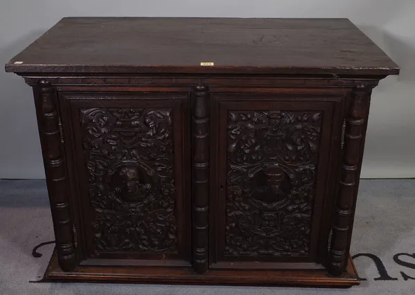 An 18th century style carved oak side cupboard, 95cm wide x 69cm high.