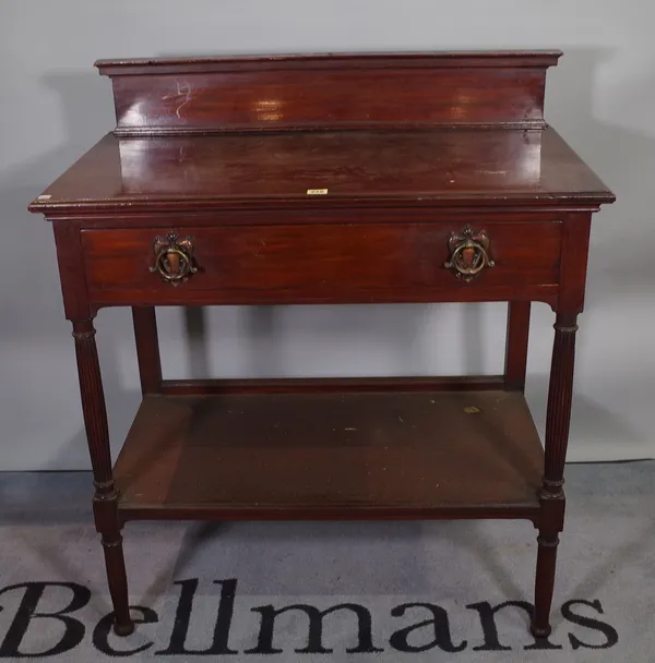 A late Victorian mahogany two tier side table on reeded tapering supports, 92cm wide x 106cm high.