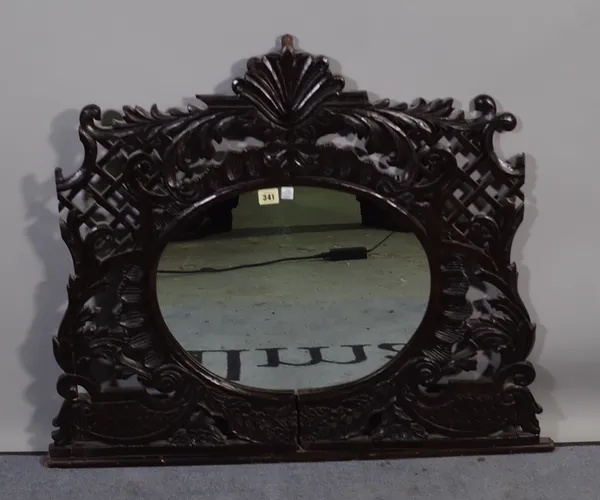 An 18th century carved wall mirror with oval mirror plate, 90cm wide x 68cm high and later sections of oak carved panelling, (qty).