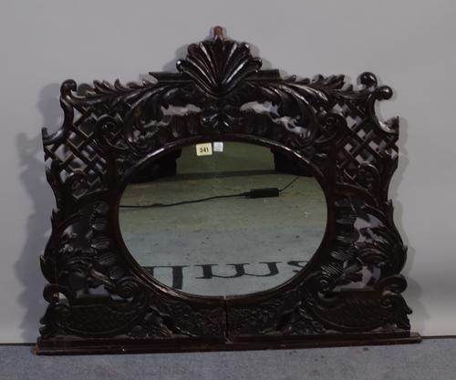 An 18th century carved wall mirror with oval mirror plate, 90cm wide x 68cm high and later sections of oak carved panelling, (qty).