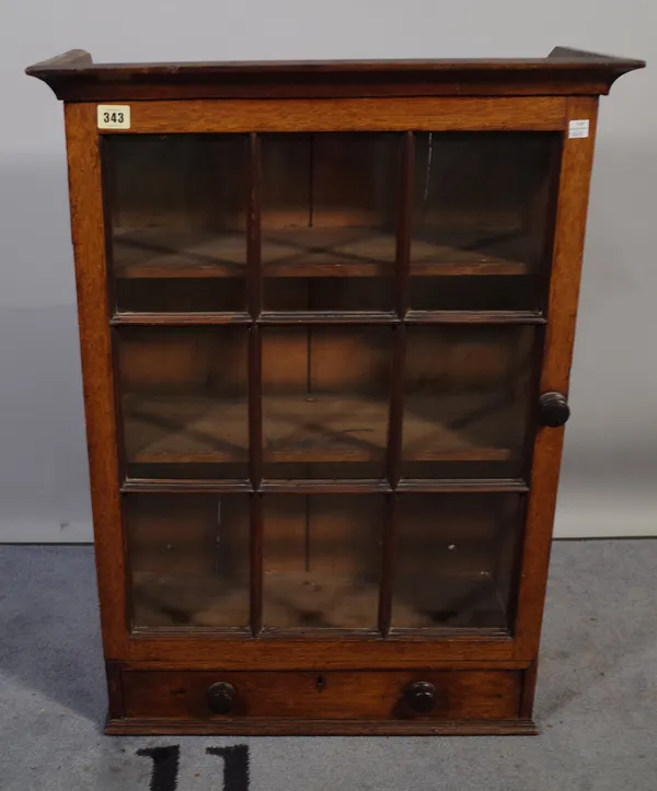 A 19th century oak hanging cupboard with panel glass door over single drawer, 58cm wide x 80cm high.