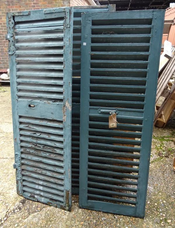 A group of three early 20th century French blue painted window shutters, 51cm wide x 148cm high, (3).