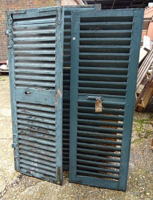 A group of three early 20th century French blue painted window shutters, 51cm wide x 148cm high, (3).