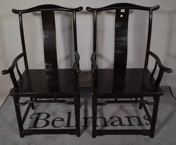 A pair of early 20th century ebonised Chinse open armchairs, 50cm wide x 94cm high (2).