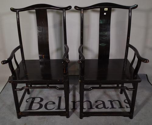 A pair of early 20th century ebonised Chinse open armchairs, 50cm wide x 94cm high (2).