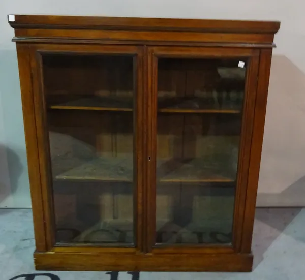 A 19th century mahogany bookcase with glazed doors on plinth base, 89cm wide x 100cm high.