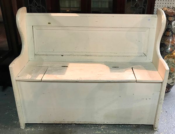 An early 20th century white painted pine settle with lift top, 114cm wide x 90cm high.