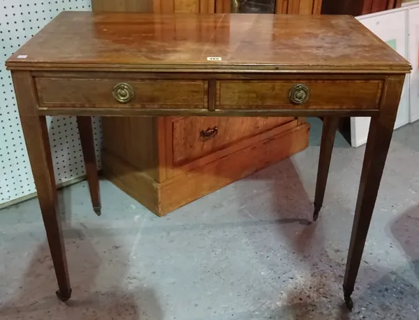 An Edwardian mahogany two drawer side table on tapering supports, 89cm wide x 75cm high.