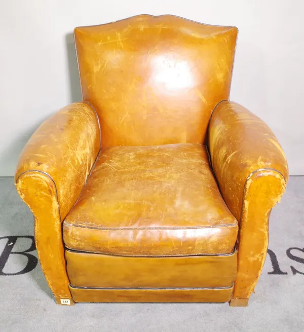 A late 19th century French club chair, with tan studded leather upholstery on tapering block supports, (a.f.).