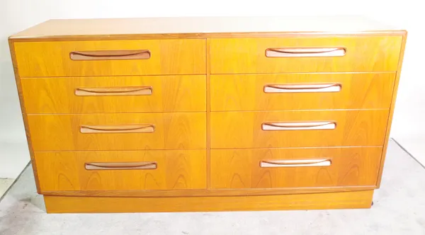 G Plan; a 20th century stained beech chest of eight single drawers, on plinth base, 142cm wide x 76cm high.