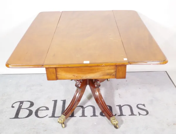 A Regency mahogany drop flap centre table, on turned column and four outswept supports, 104cm wide x 72cm high.