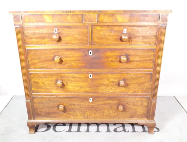 A Regency mahogany chest with a pair of hidden frieze drawers over two short and three long drawers, on ogee bracket feet, 118cm wide x 112cm high.