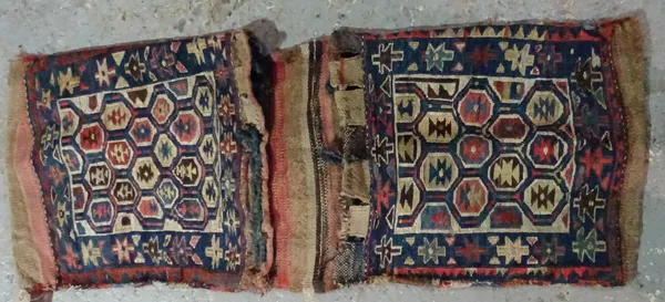 An Antique Caucasian Soumak Khorjin saddlebag, each bag face with honeycomb design filled with polychrome octagonal guls, deep blue border, plain reve