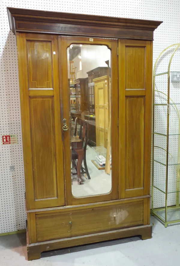 An Edwardian mahogany double wardrobe, with mirrored central door over single drawer base, 130cm wide x 198cm high.