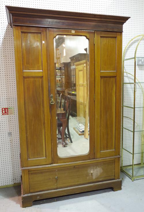 An Edwardian mahogany double wardrobe, with mirrored central door over single drawer base, 130cm wide x 198cm high.