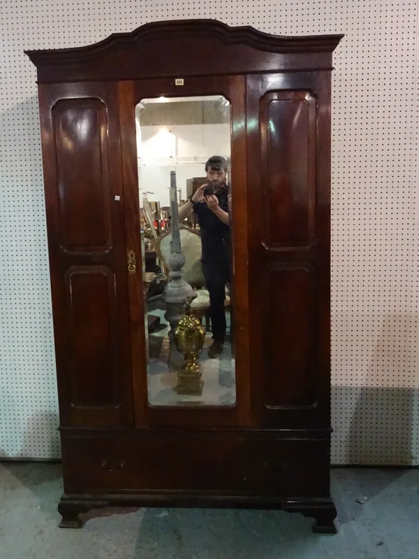 A Victorian mahogany double wardrobe, with mirrored central door over single drawer base, on bracket feet, 145cm wide x 200cm high.