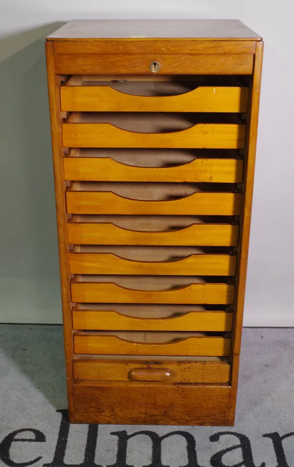 A 20th century oak filing cabinet with tambour door, 49cm wide x 110cm high.