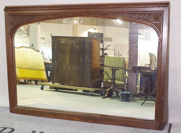 A large Victorian oak mirror, with arch plate and floral carved corner spandrels, 170cm wide x 118cm high.