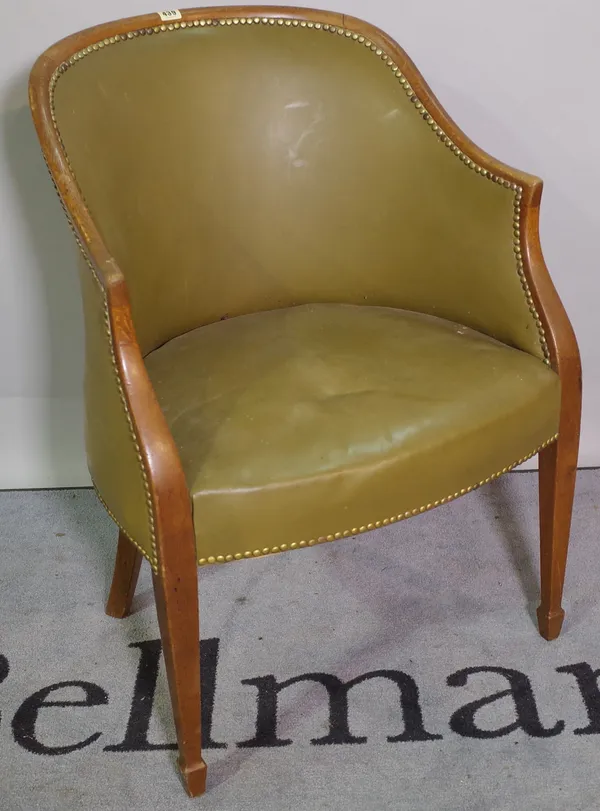 A 20th century oak framed tub chair with studded leather upholstery on tapering supports.