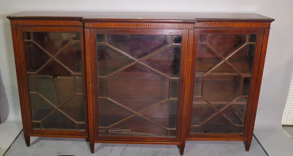 Spillman & Co London; a Regency style mahogany breakfront bookcase with astragal glazed doors on tapering square supports 183cm wide x 86cm high.