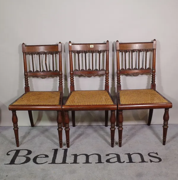 A set of six early 19th century Anglo-Indian teak framed dining chairs with bobbin and split bullseye decoration, on turned supports, 45cm wide x 85cm