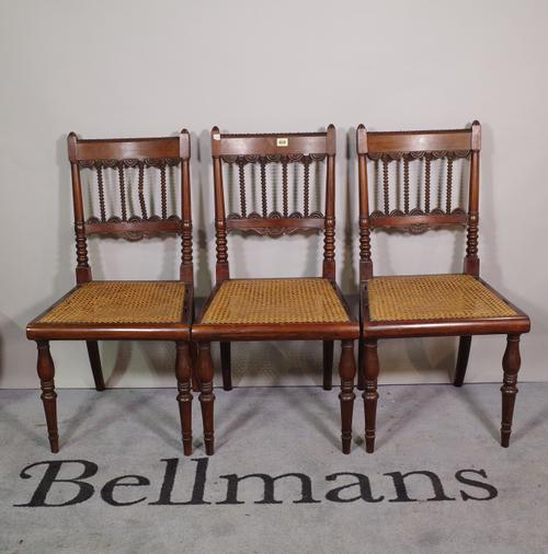 A set of six early 19th century Anglo-Indian teak framed dining chairs with bobbin and split bullseye decoration, on turned supports, 45cm wide x 85cm