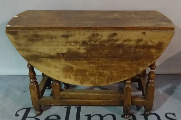 An 18th century and later oak gateleg table, on turned supports 112cm wide x 77cm high.