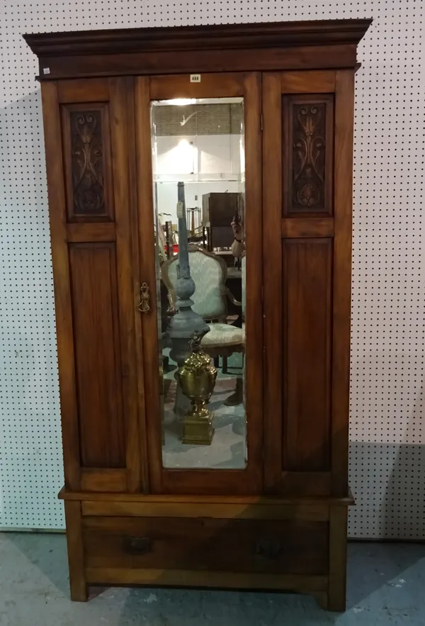 A late Victorian mahogany single wardrobe with mirrored door on single drawer plinth base, 105cm wide x 196cm high.