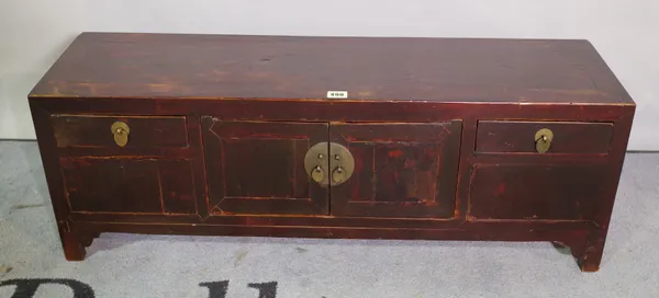 A 20th century Chinese hardwood low cabinet, with cupboard doors flanked by single drawers, 98cm wide x 35cm high.