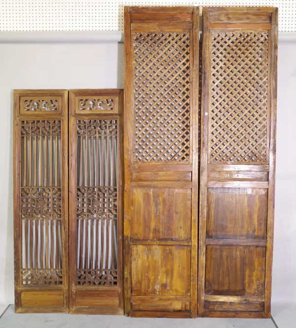 Two pairs of 20th century Chinese hardwood screens, the largest 56cm wide x 230cm high, the smaller pair 42cm wide x 174cm high.