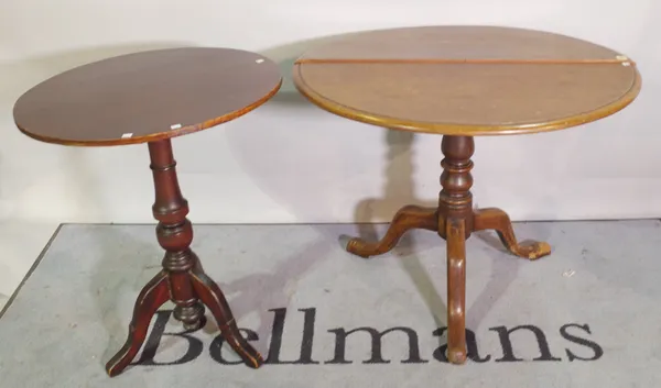 A 19th century mahogany tripod table on three outswept supports 87cm wide x 70cm high and another smaller, 61cm wide x 75cm high, (2).