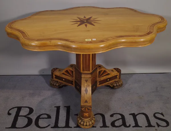 A late 19th century continental beech and specimen wood inlaid serpentine centre table on octagonal turned central column, on bun feet, 119cm wide x 7