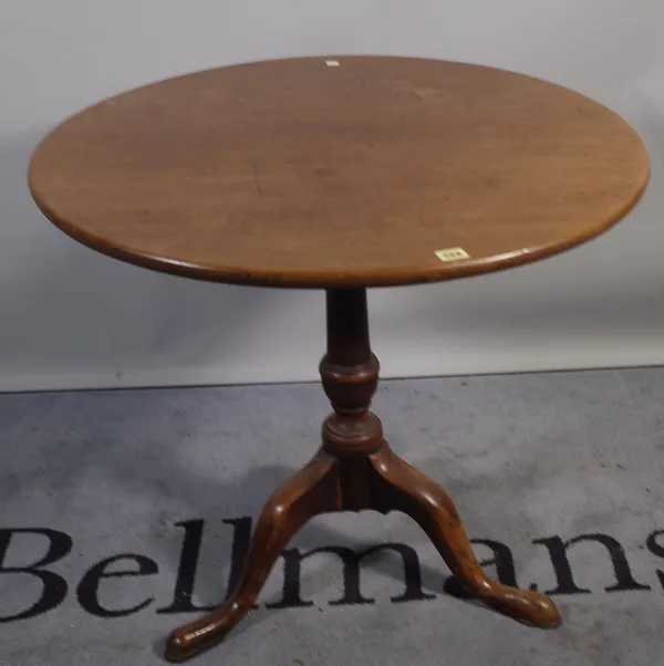 A George III mahogany tripod table on tapering turned column and three downswept supports, 77cm diameter x 72cm high.