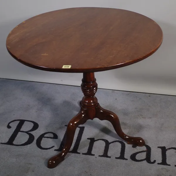 A late George III mahogany tripod table with birdcage mount over tapering turned column on three downswept supports, 77cm diameter x 72cm high.