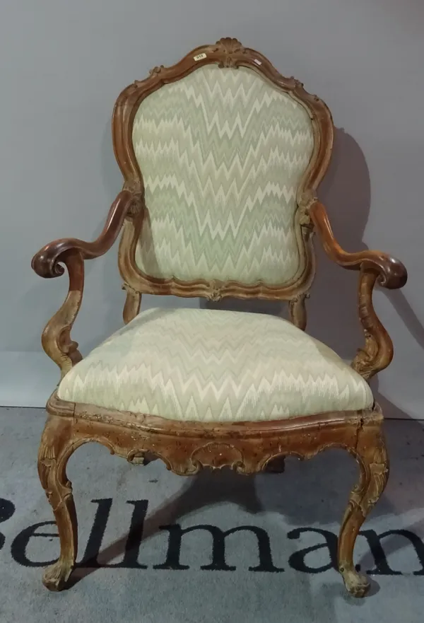 A late 19th century Continental beech open armchair, on shell capped cabriole supports, (a.f).