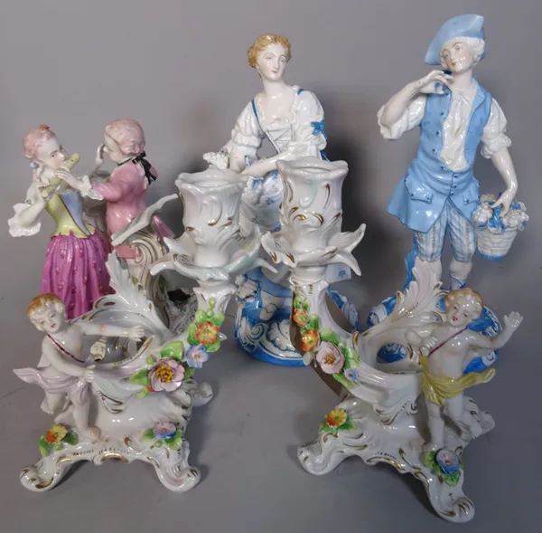Ceramics, comprising; a pair of 20th century German candle holders, 17cm high, a German figural group, 17cm high and two further figures, 20cm high.