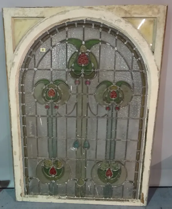 An early 20th century Art Nouveau style stained glass window, depicting a Glasgow Rose, 95cm wide x 132cm high.
