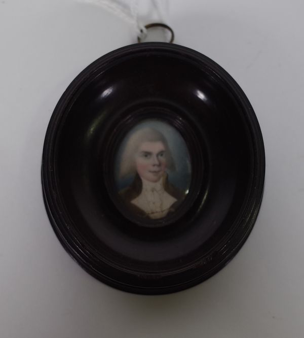 Late 18th century English School, a portrait miniature on ivory of Dr McCann, in an oval wooden frame, image 3.5cm high (a/f). CAB