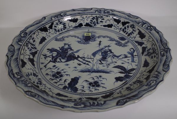 A very large Chinese blue and white Ming style dish, modern, painted with two figures on horseback, 59cm diameter.